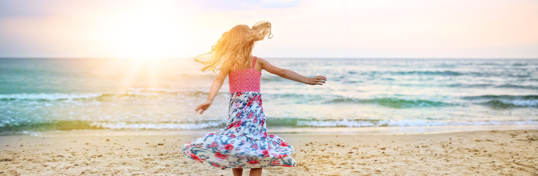 carefree girl dancing on the beach in a dress carefree girl dancing on the beach in a dress