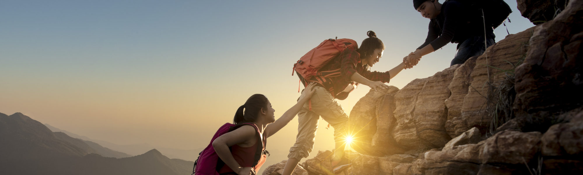 Group of Asia hiking help each other silhouette in mountains with sunlight. Group of Asia hiking help each other silhouette in mountains with sunlight.
