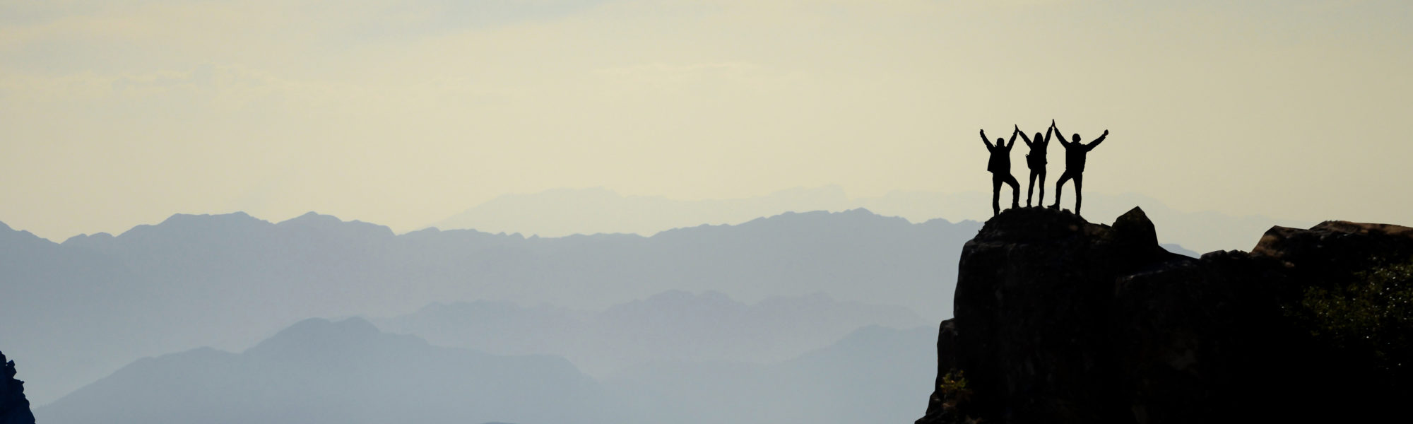 successful climbers, mountain range and spectacular depth successful climbers, mountain range and spectacular depth