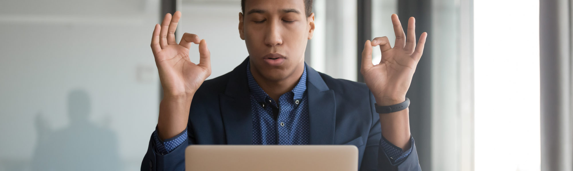 Calm mindful black businessman in suit meditate at work desk Calm mindful black businessman in suit meditate at work desk