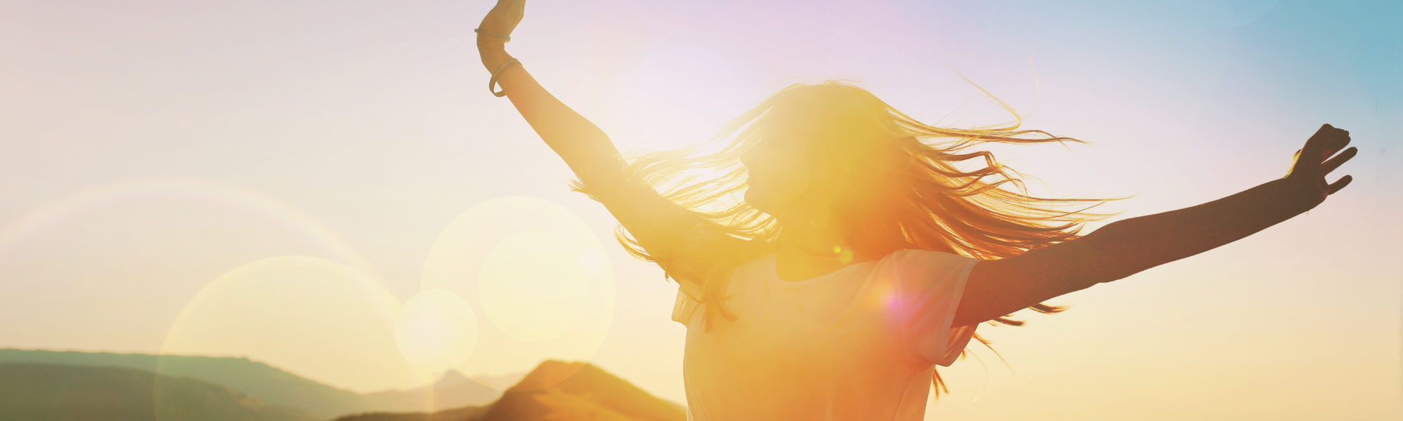 Girl on a background of mountains joyful spread her arms dancing at a height Girl on a background of mountains joyful spread her arms dancing at a height